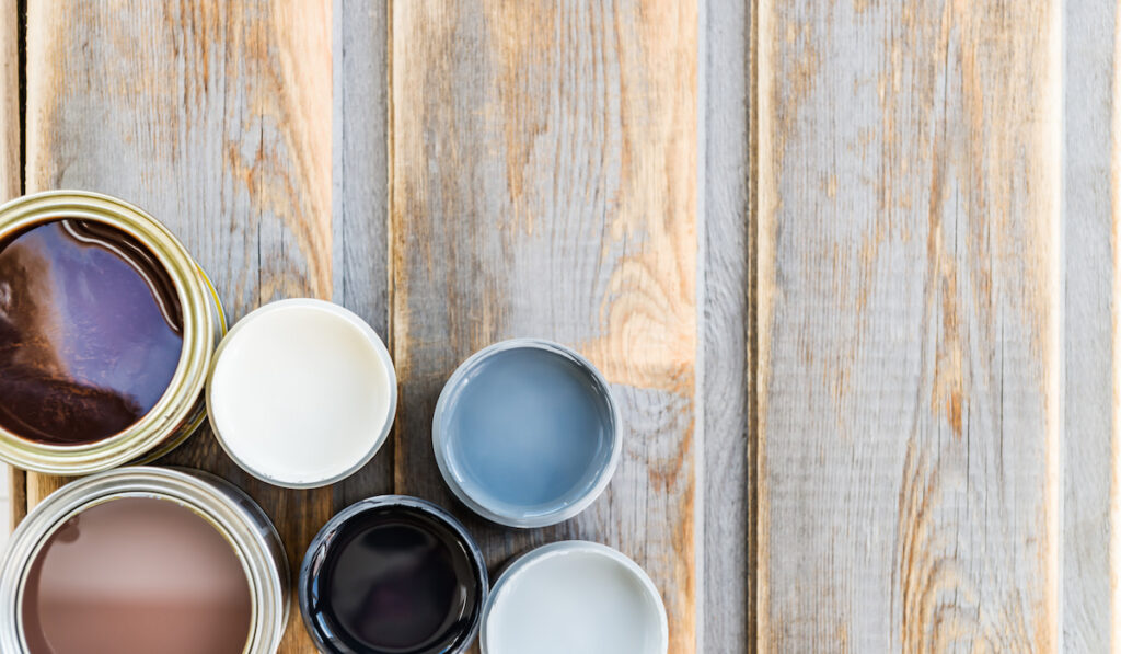 open cans of paint, varnish and stains