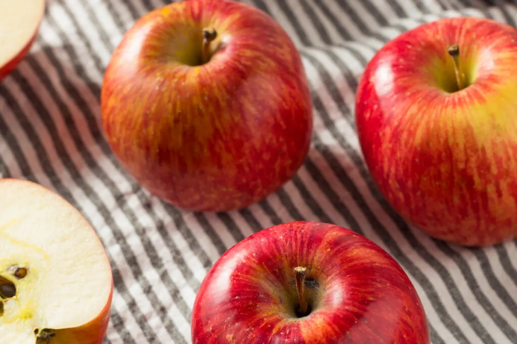 Red Organic Kiku Apples on a cloth on the table