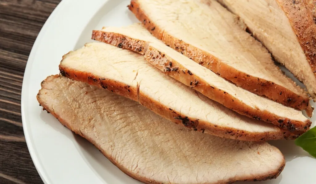 sliced cooked turkey on a white plate