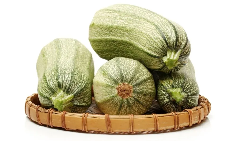 zucchini on a wooden tray in a white background