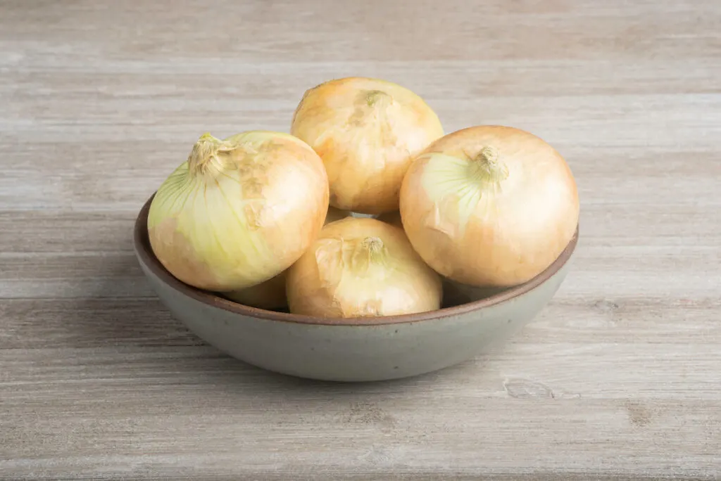 Vidalia Onions in a wooden bowl on a table 