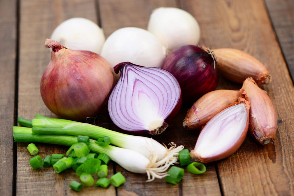 Shallots and Onions on a wooden table 