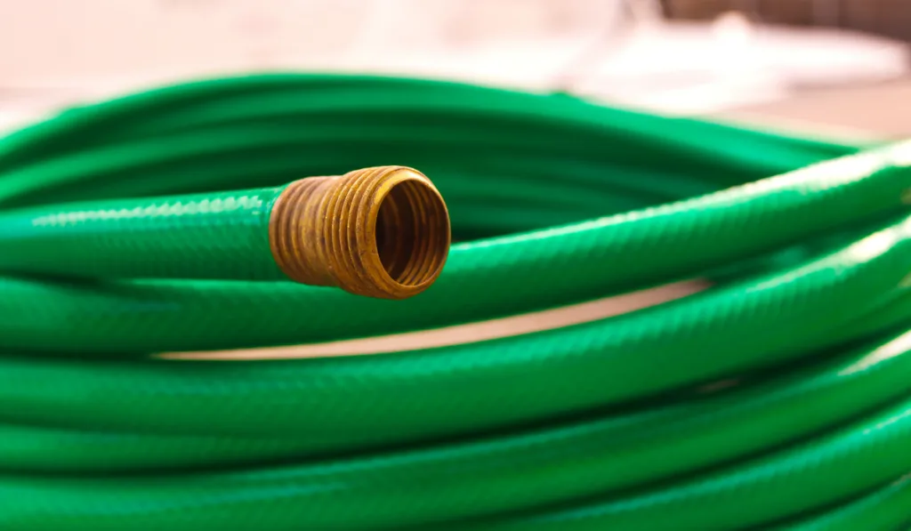 Green coiled rubber hose
