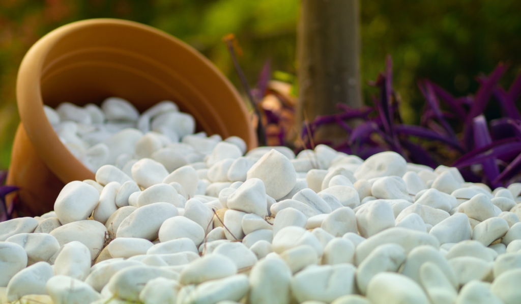 Snow white pebble stones inside a flower pot as a garden decoration
