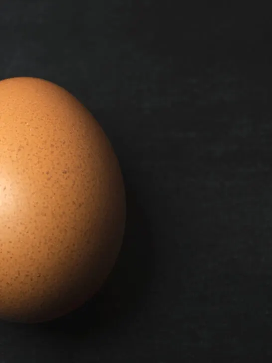 a brown egg on a black table