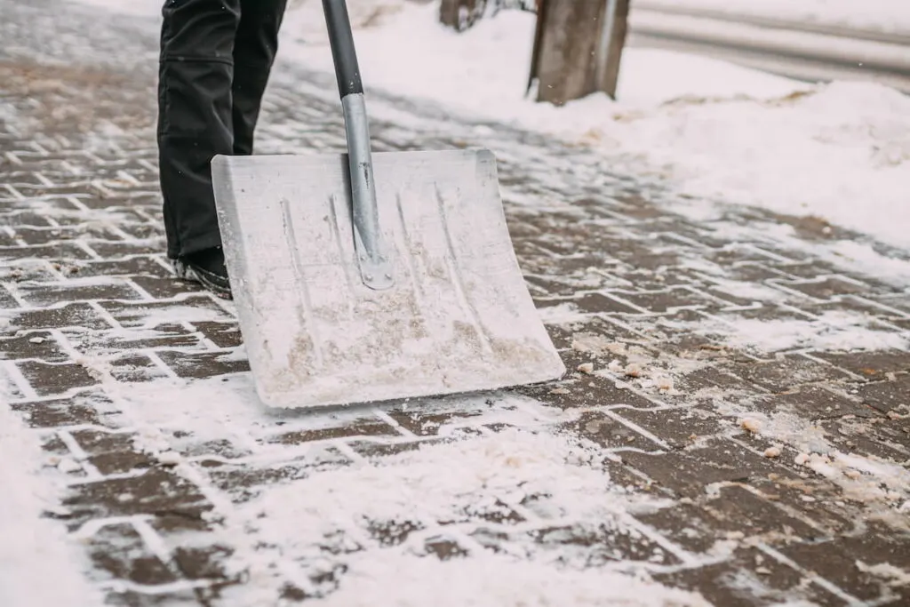 Clearing snow using snow shovel 