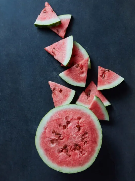 Slice of watermelon on black background - ee230529