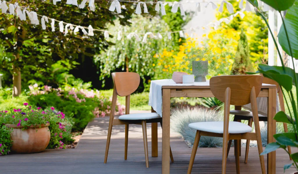 Wooden table and chairs in the summer garden

