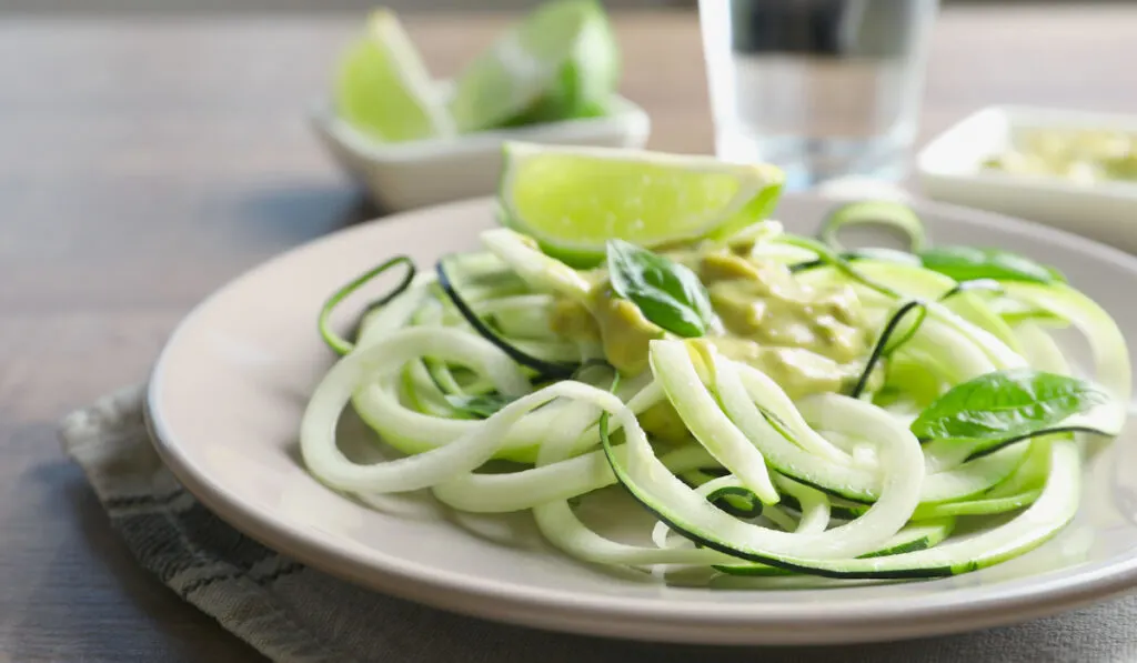 Cucumber noodleo on a plate with slice of lemon