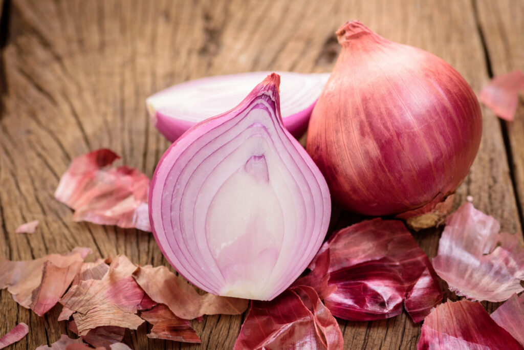 Peeled and sliced onion on the table
